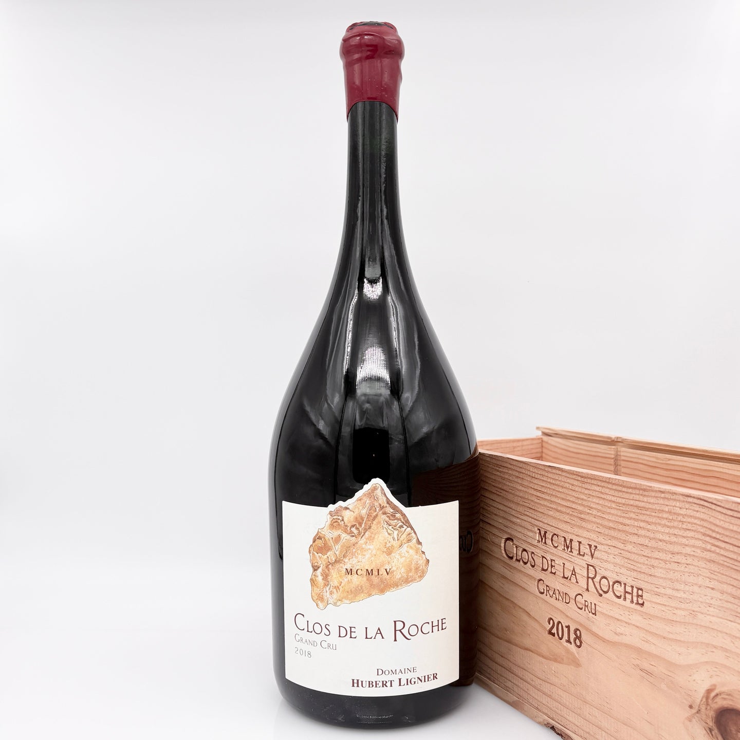 Wine bottle with label and wooden box on a white background