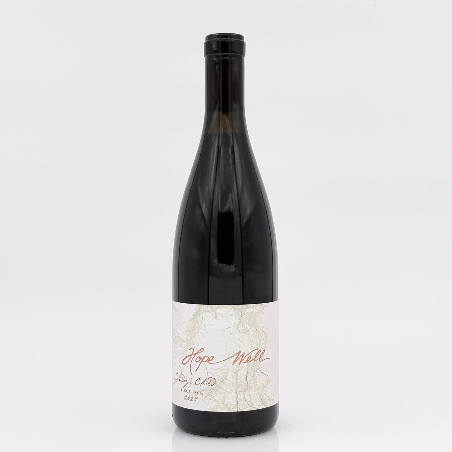Wine bottle with a white label on a light gray background