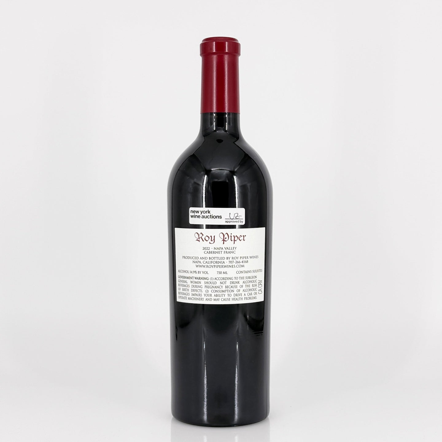Red wine bottle with a visible label on a white background