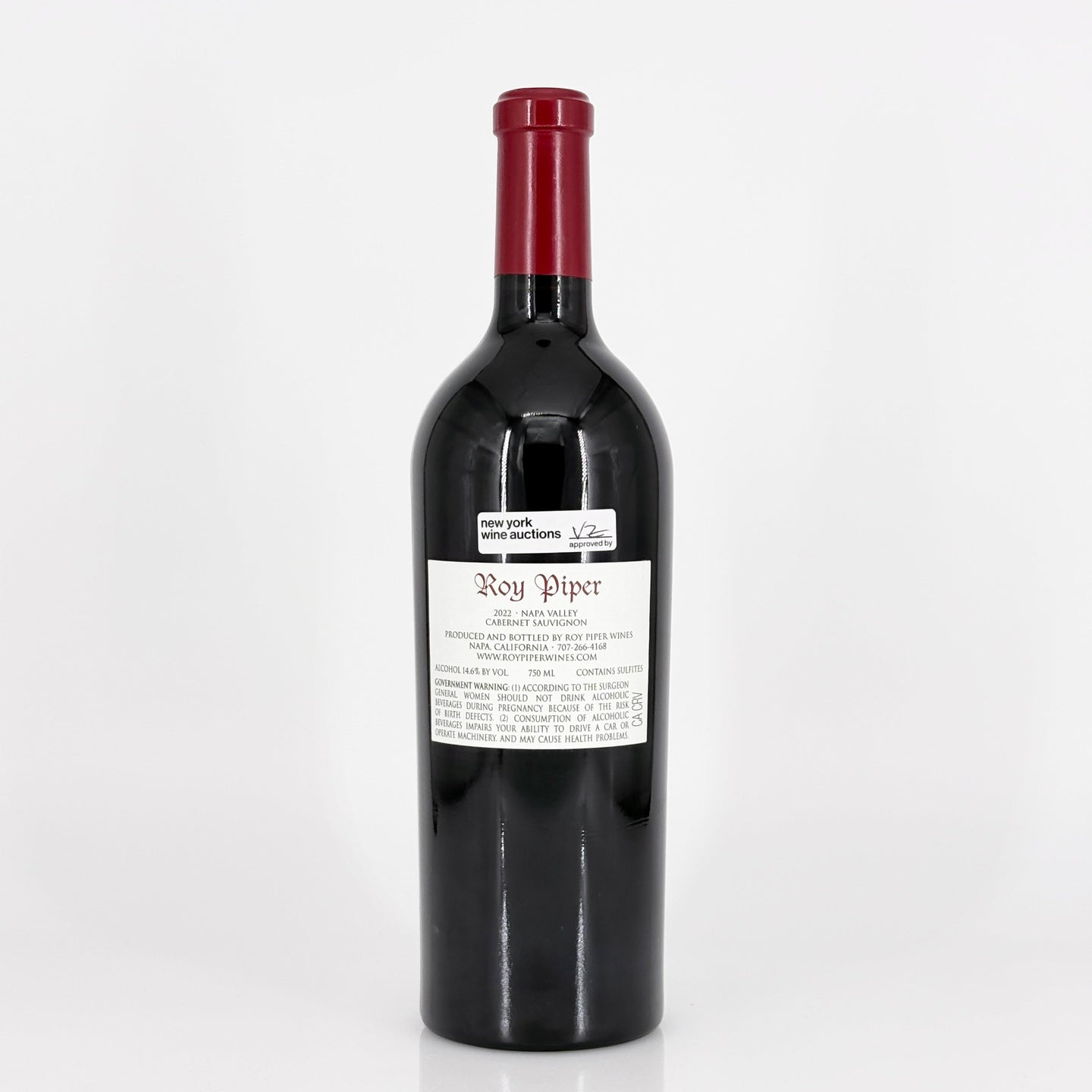 Red wine bottle with a visible label on a white background