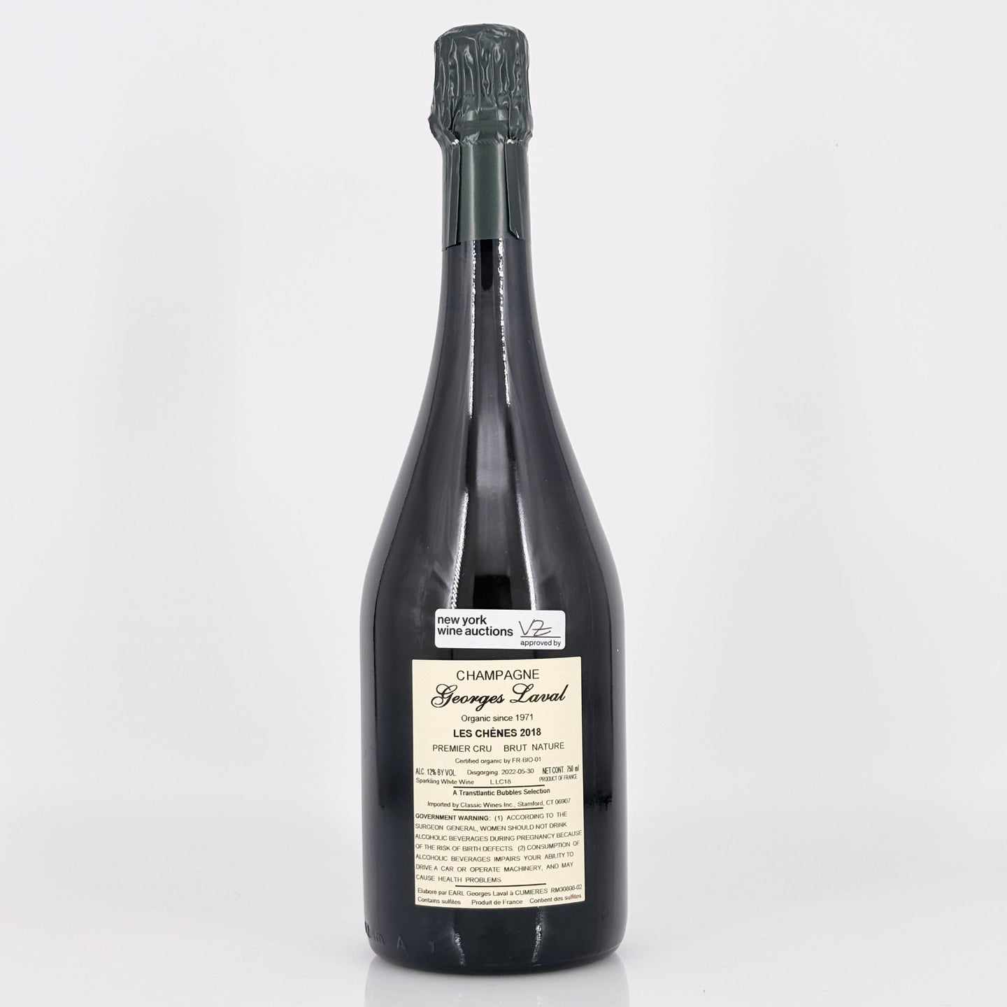 Bottle of champagne with a label on a white background
