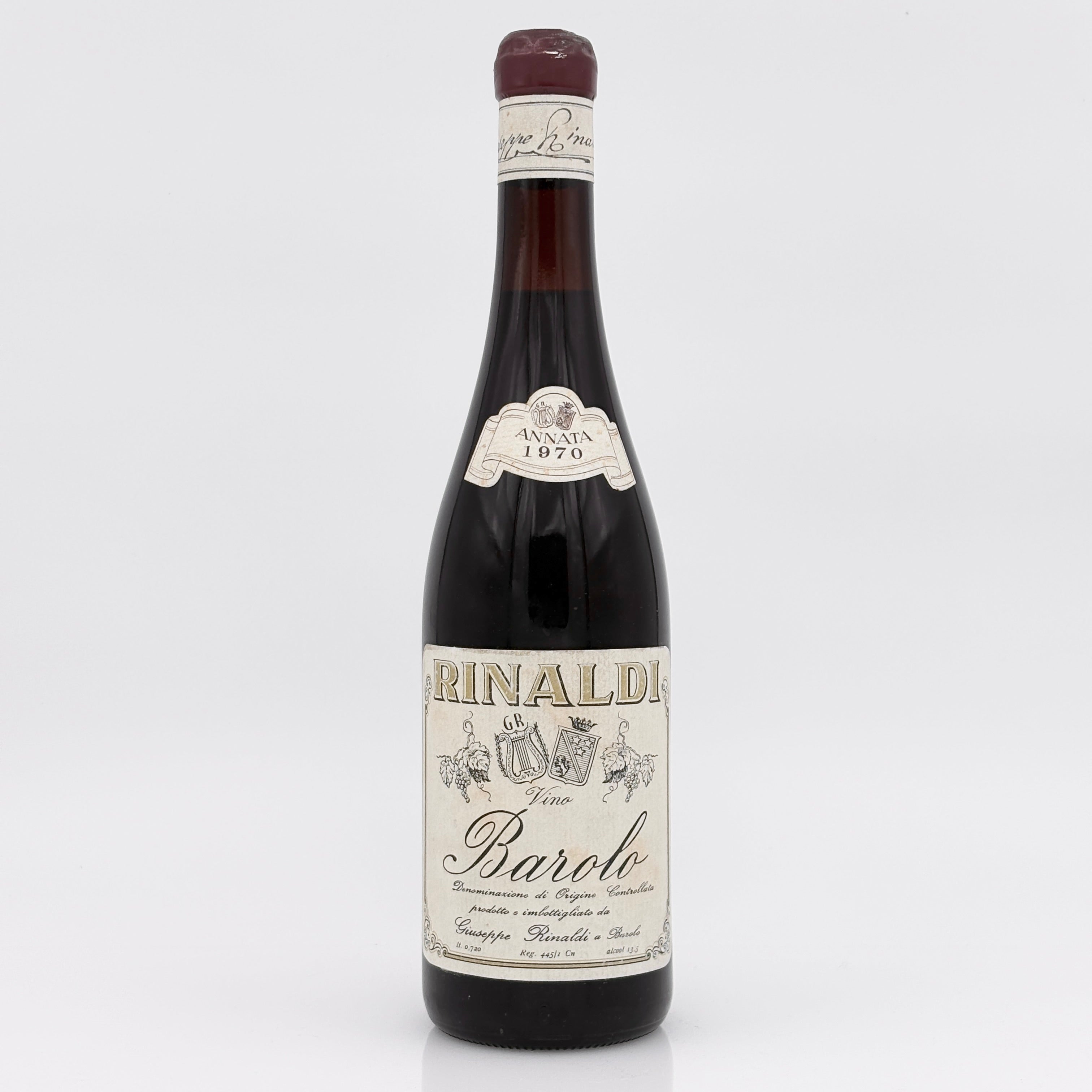 Red wine bottle with white label on a white background