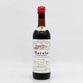 Vintage Barolo wine bottle with a white label on a light gray background