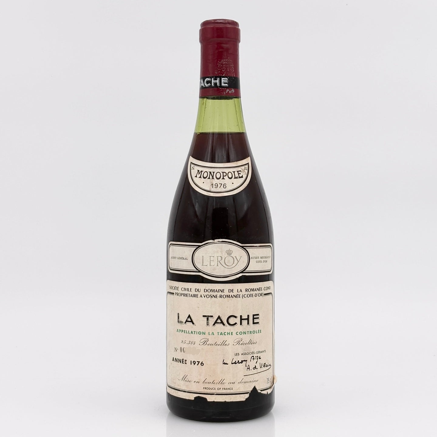 Vintage wine bottle labeled 'La Tache' on a white background
