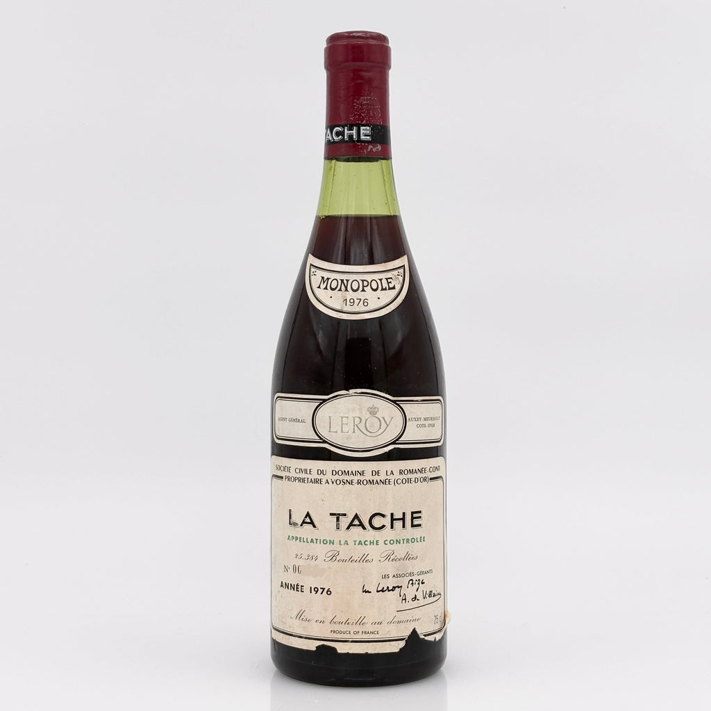 Vintage wine bottle labeled 'La Tache' on a white background