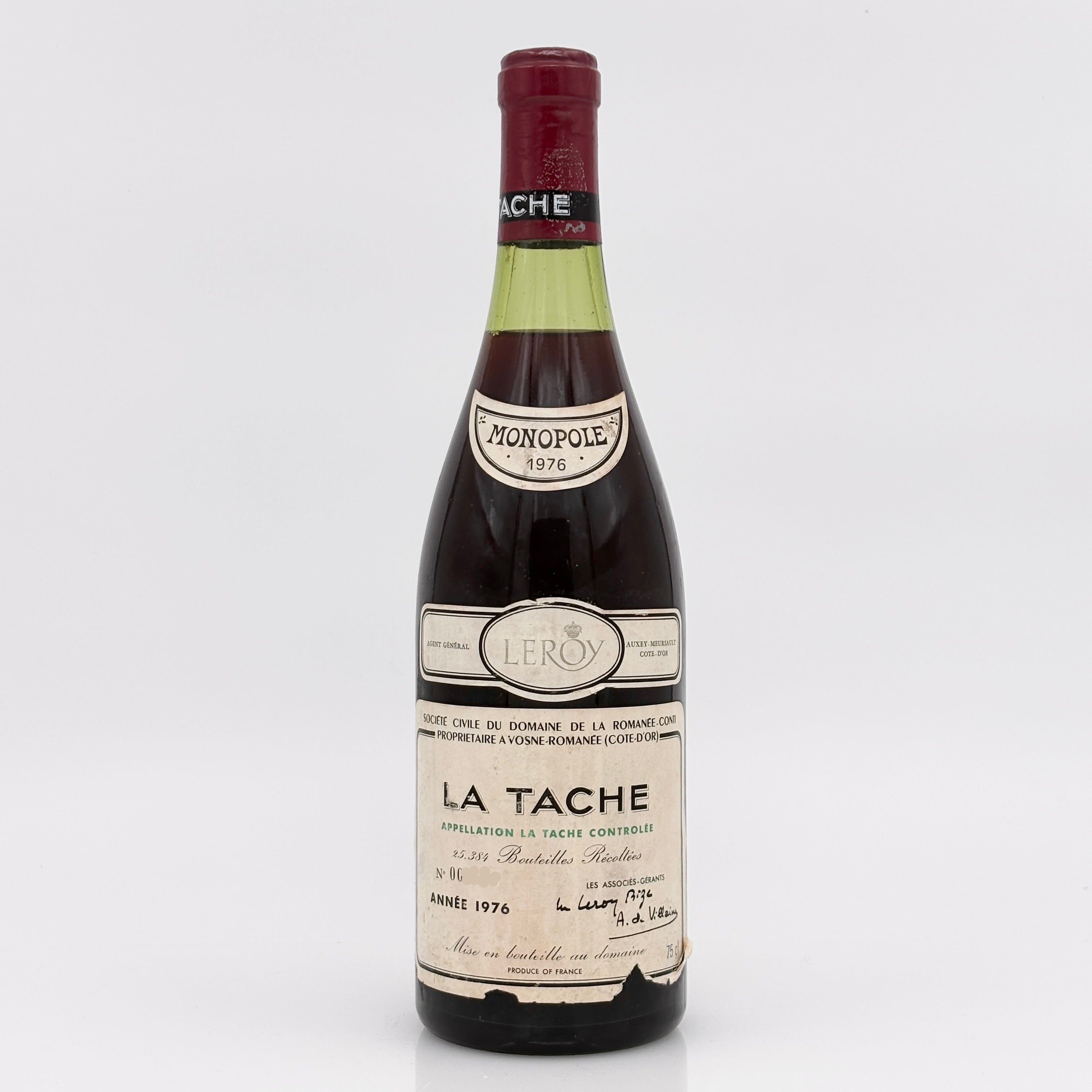 Vintage wine bottle labeled 'La Tache' on a white background