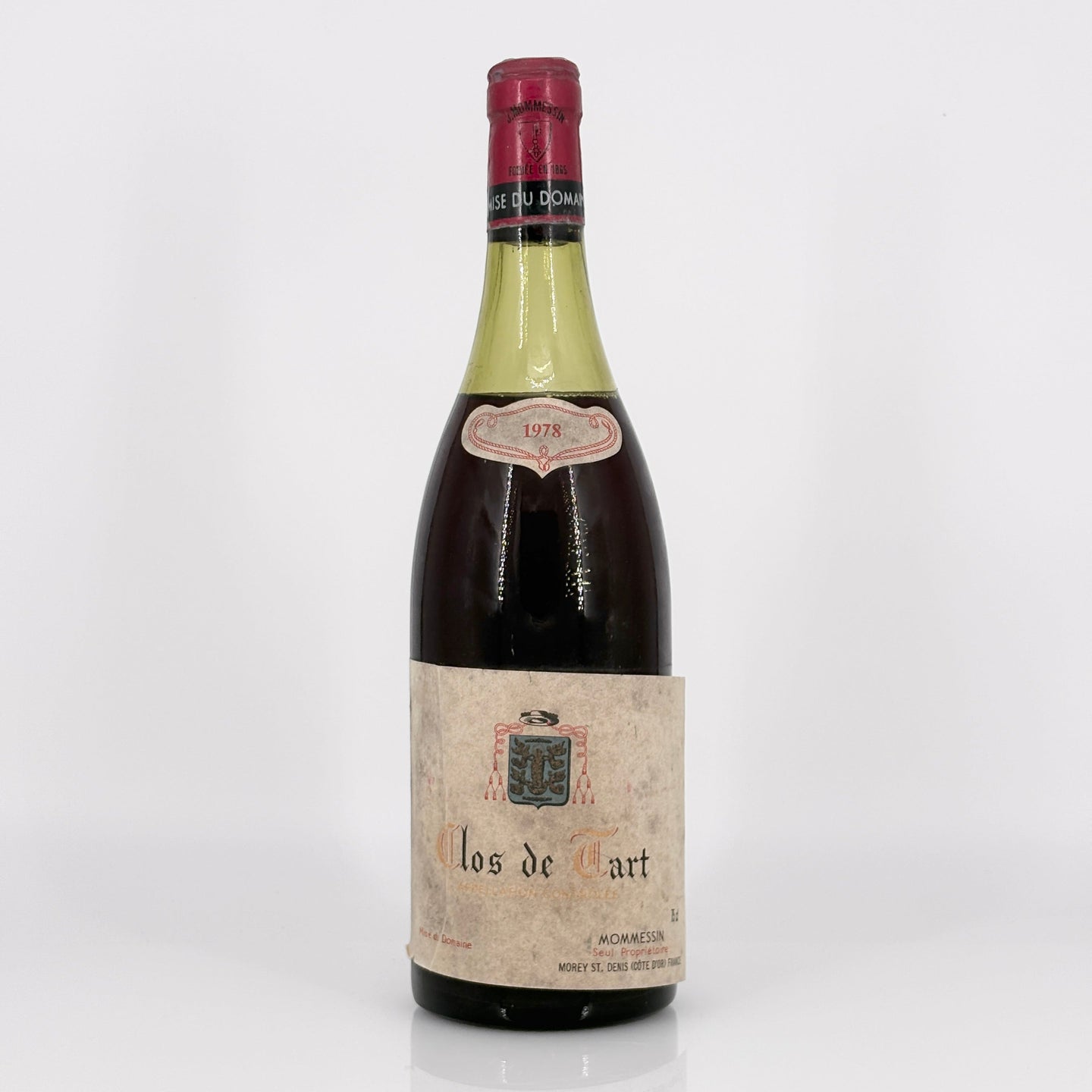 Vintage wine bottle labeled 'clos de tart' on a white background