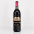 Red wine bottle with a prominent label on a white background