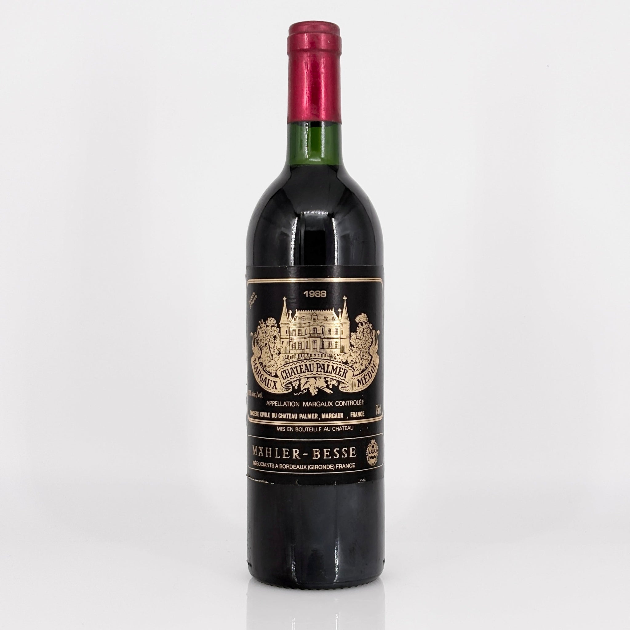 Red wine bottle with a prominent label on a white background