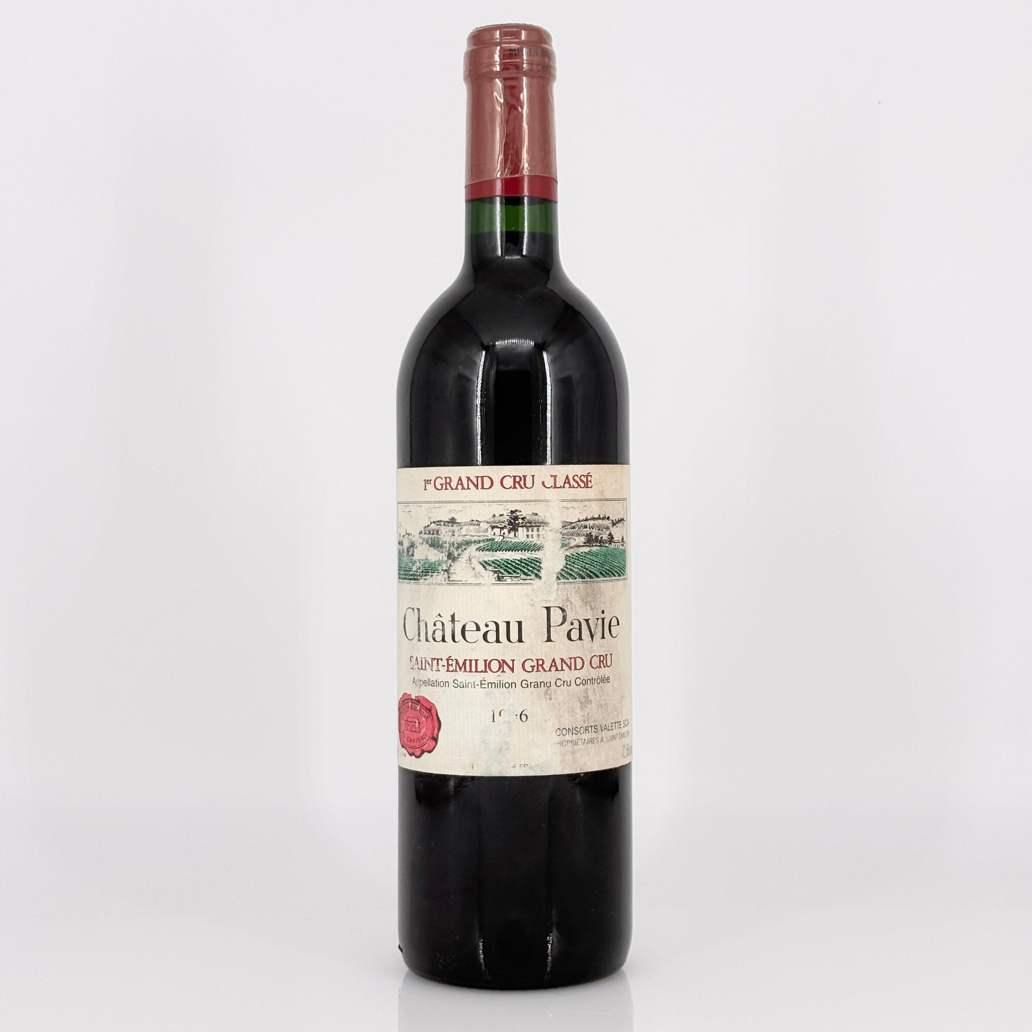 Red wine bottle with a visible label on a white background