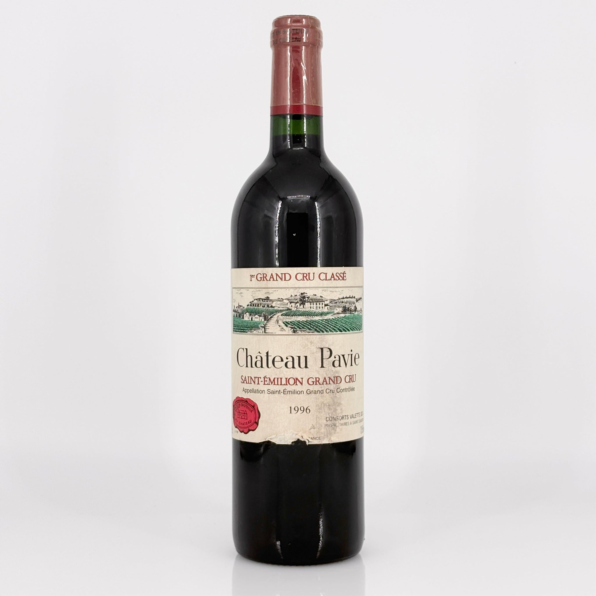 Red wine bottle with Chateau Pavie label on a white background