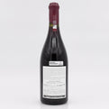 Red wine bottle with a visible label on a white background