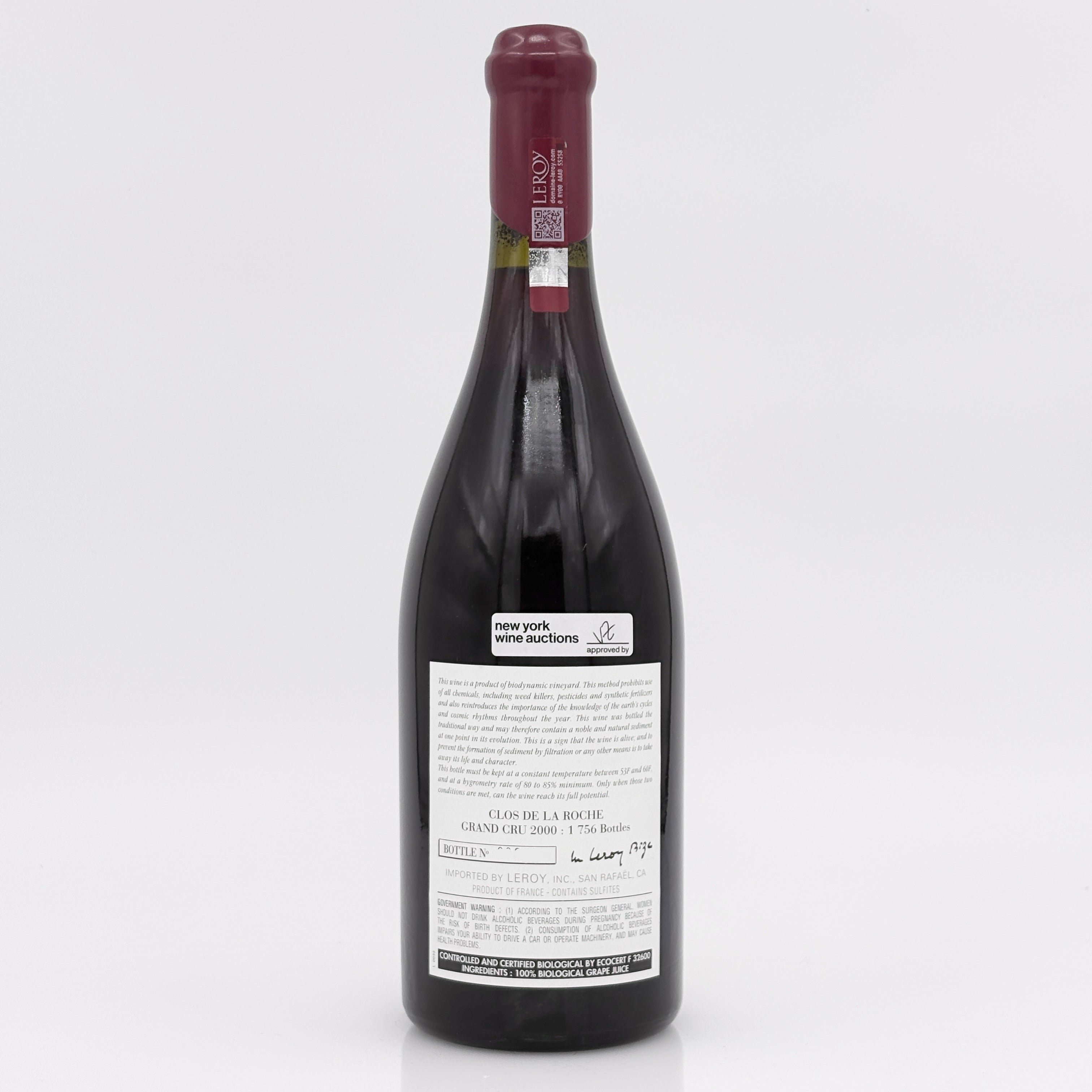 Red wine bottle with a visible label on a white background