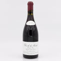 Red wine bottle with a white label on a light gray background