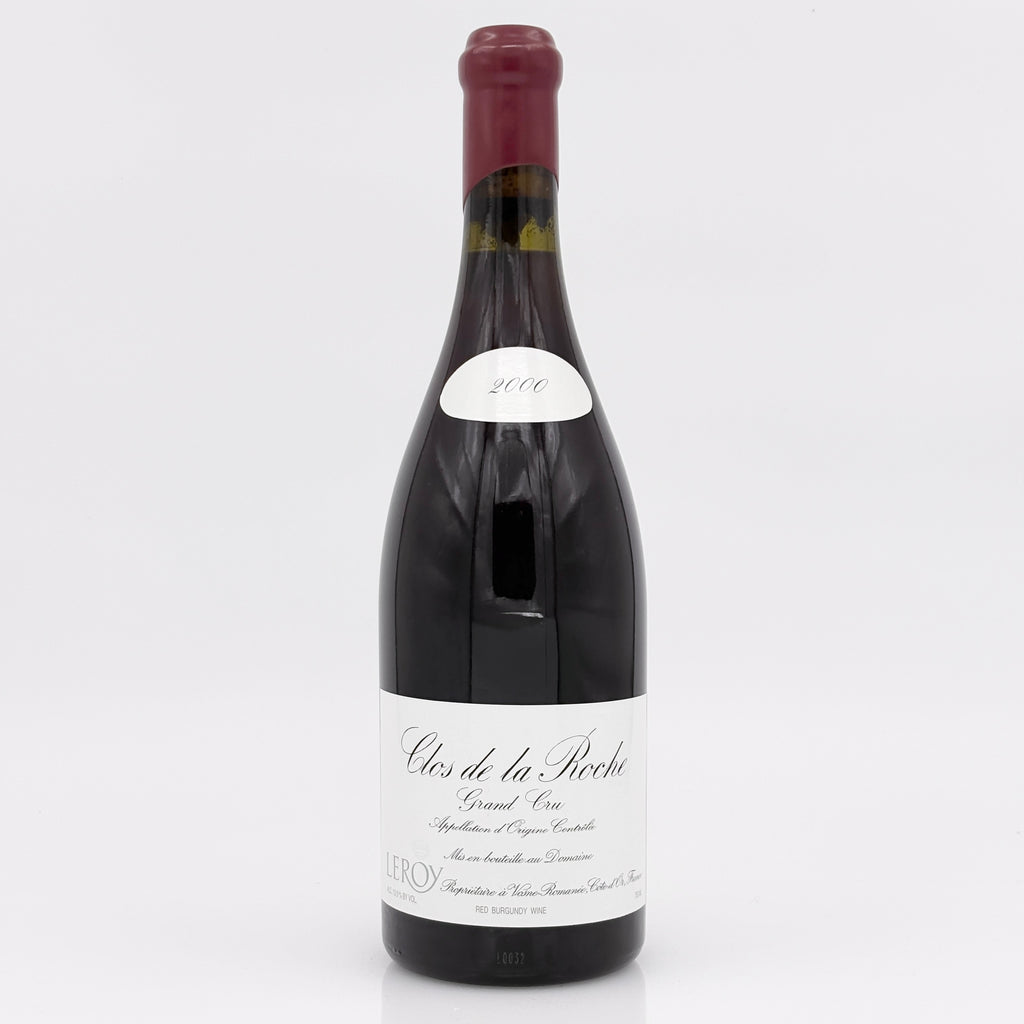 Red wine bottle with a white label on a light gray background