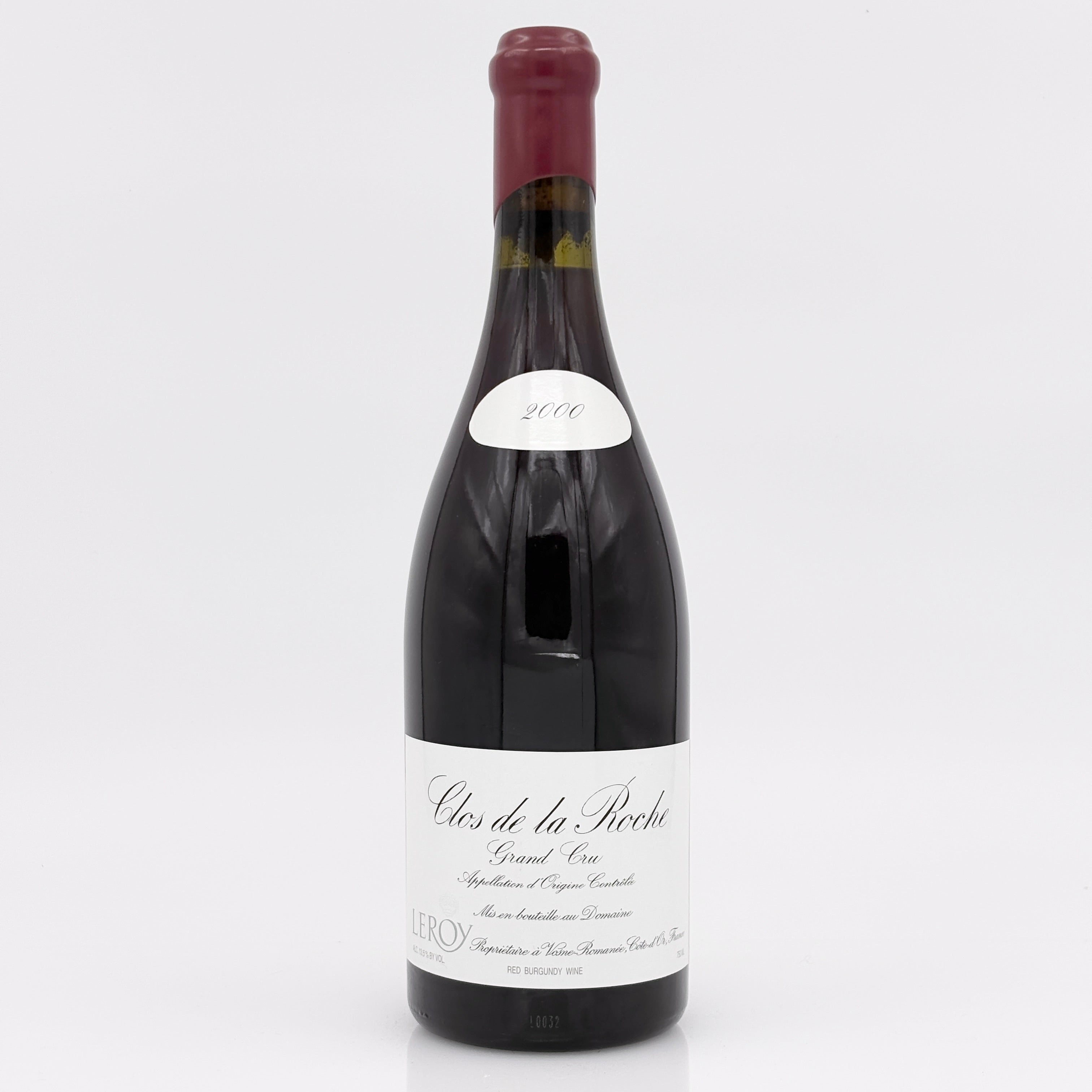 Red wine bottle with a white label on a light gray background