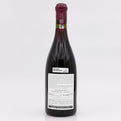 Red wine bottle with a visible label on a white background