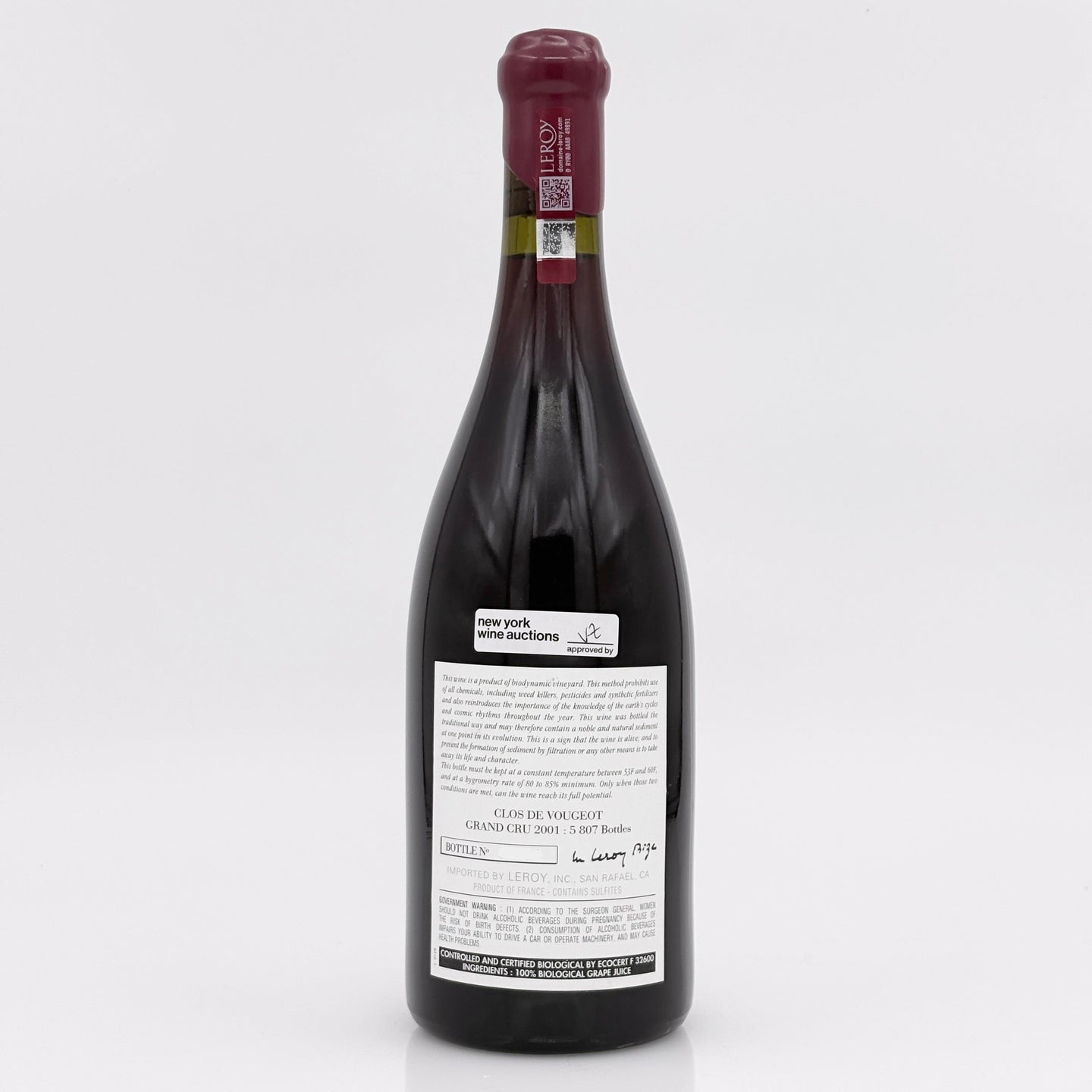 Red wine bottle with a visible label on a white background