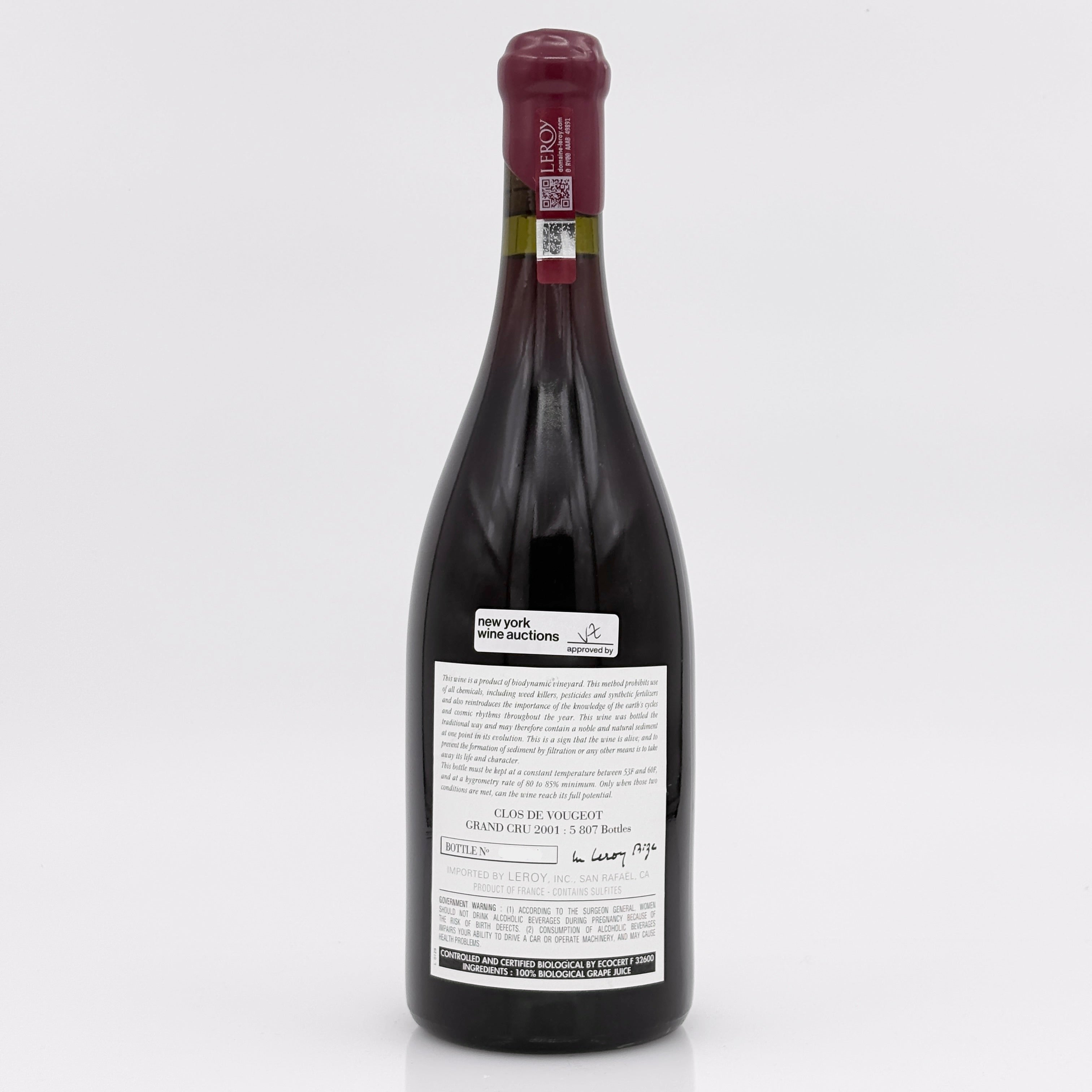 Red wine bottle with a visible label on a white background
