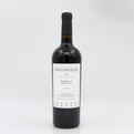 Red wine bottle with a label on a white background