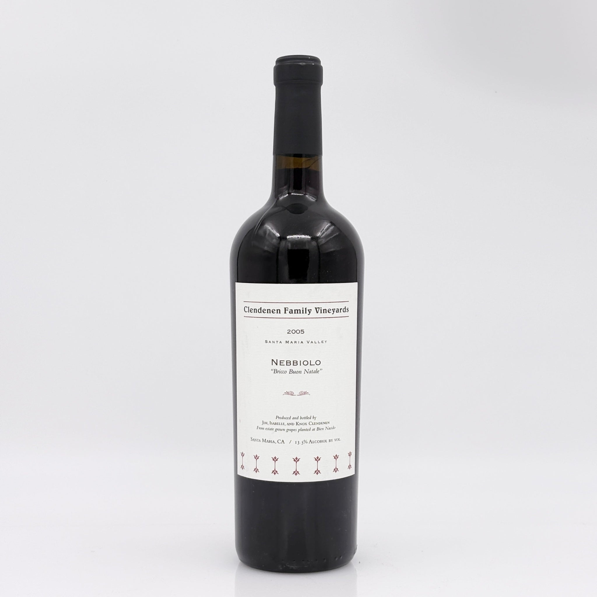 Red wine bottle with a label on a white background