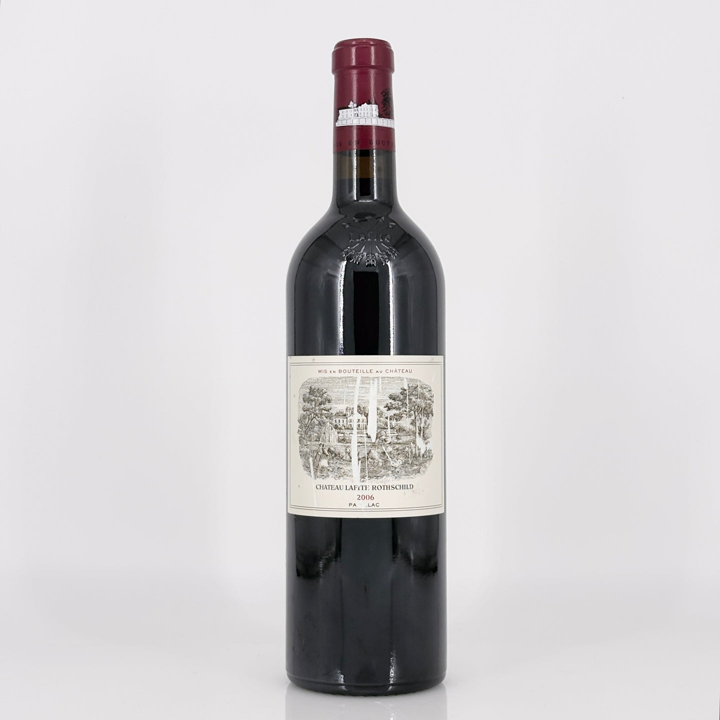 Red wine bottle with a label on a white background