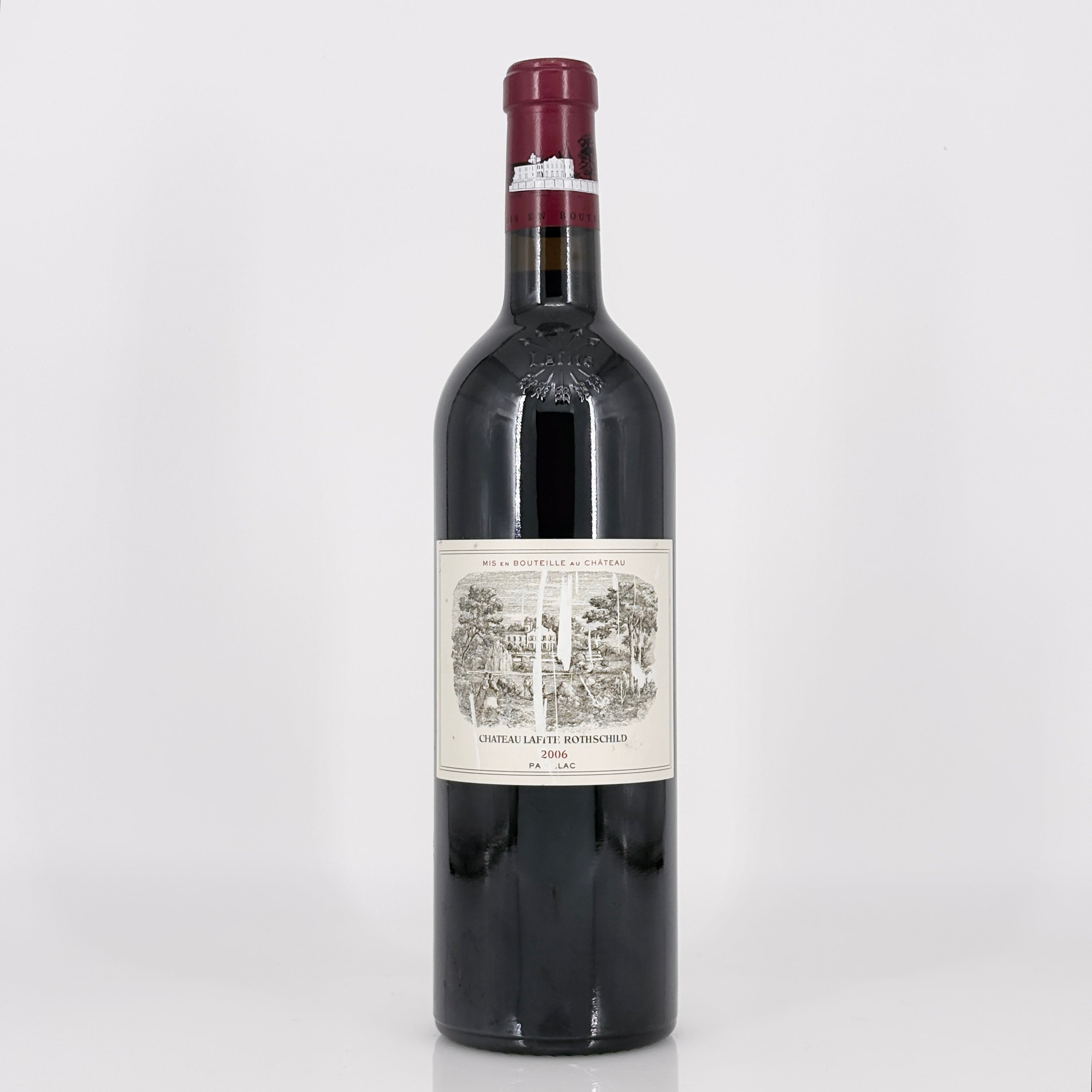 Red wine bottle with a label on a white background