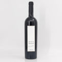 Wine bottle with a white label on a light gray background