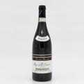 Wine bottle with 'Riserva' label on a white background