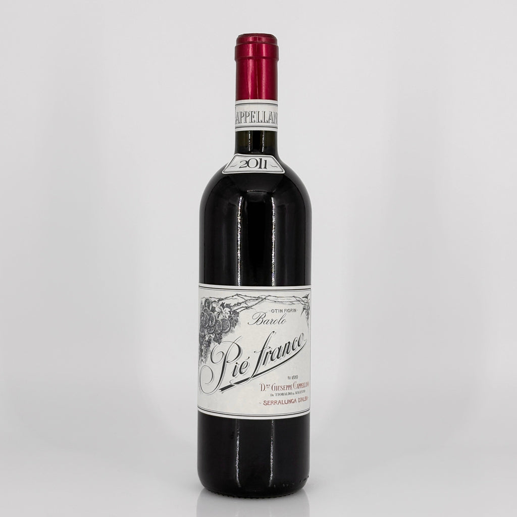 Red wine bottle with a visible label on a white background