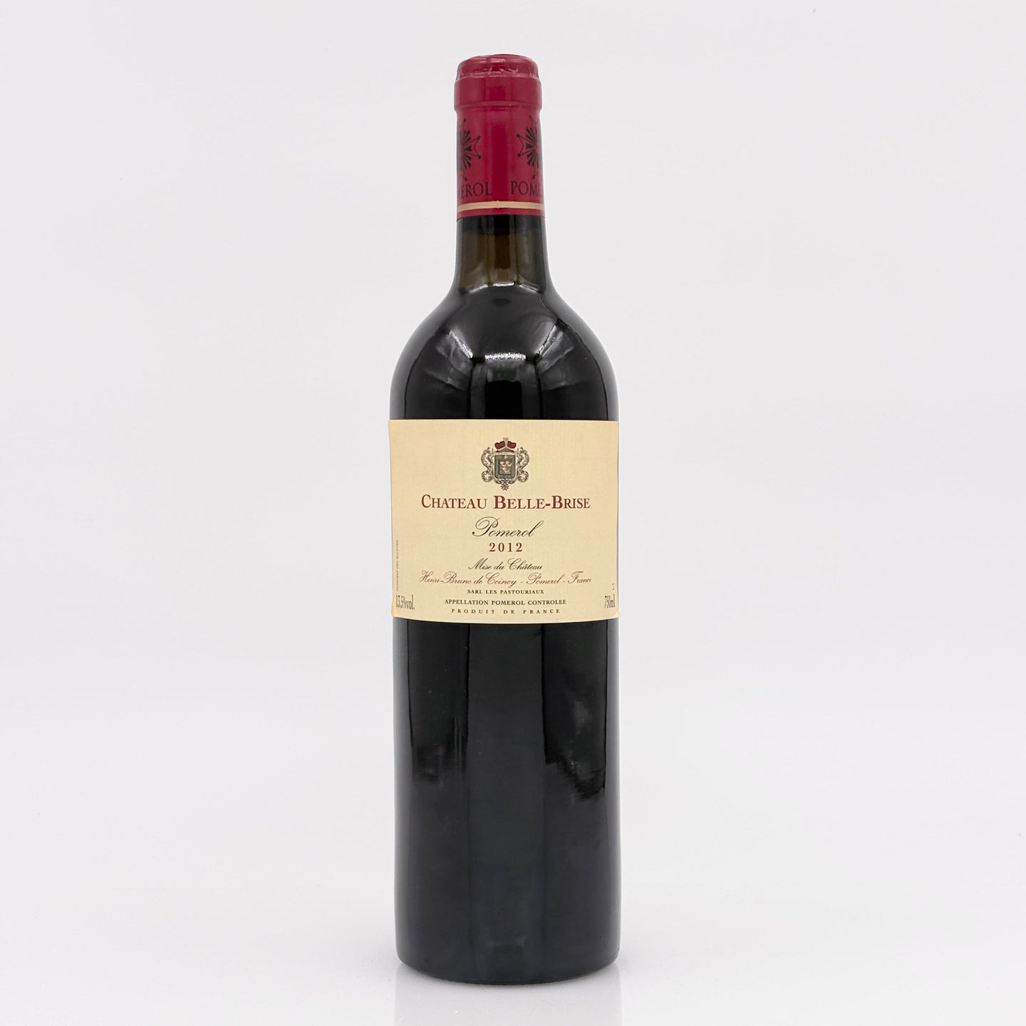 Red wine bottle with a visible label on a white background