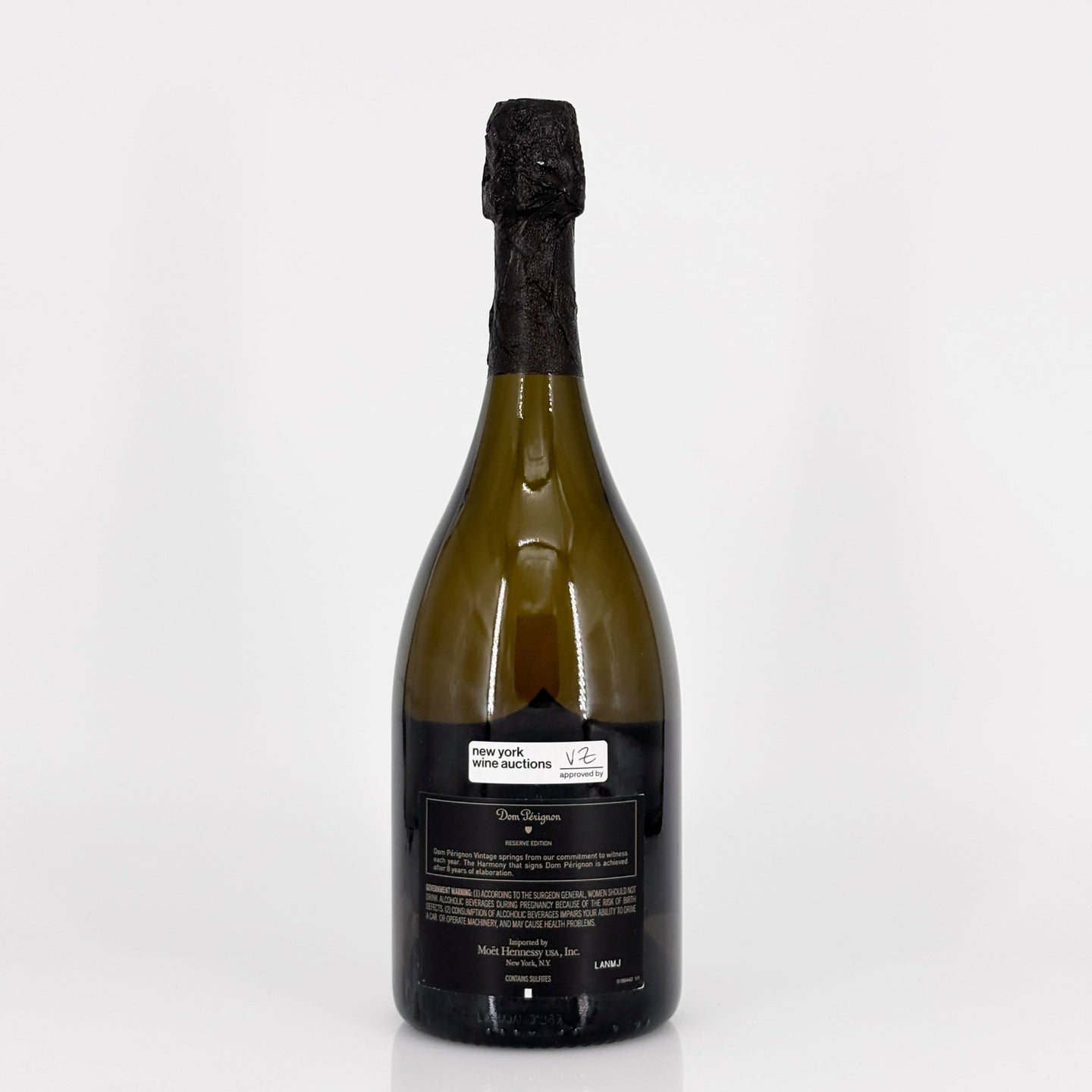 Bottle of champagne with a black cork on a white background