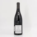 Black wine bottle with label on a white background