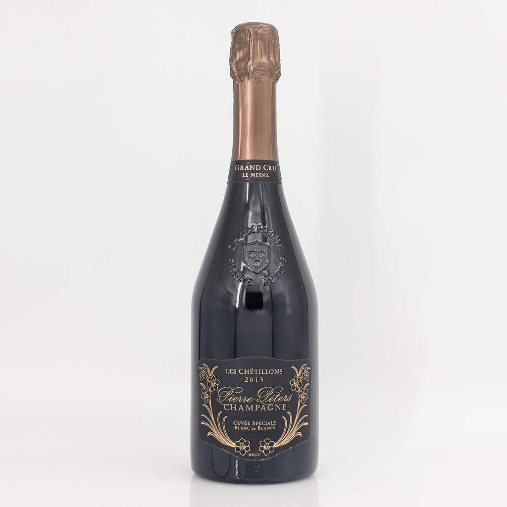 Bottle of champagne with a decorative label on a white background