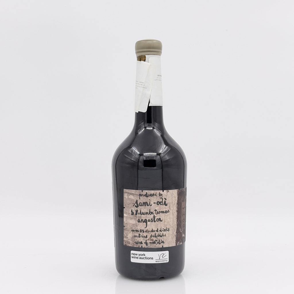 Bottle of dark liquid with a label on a white background