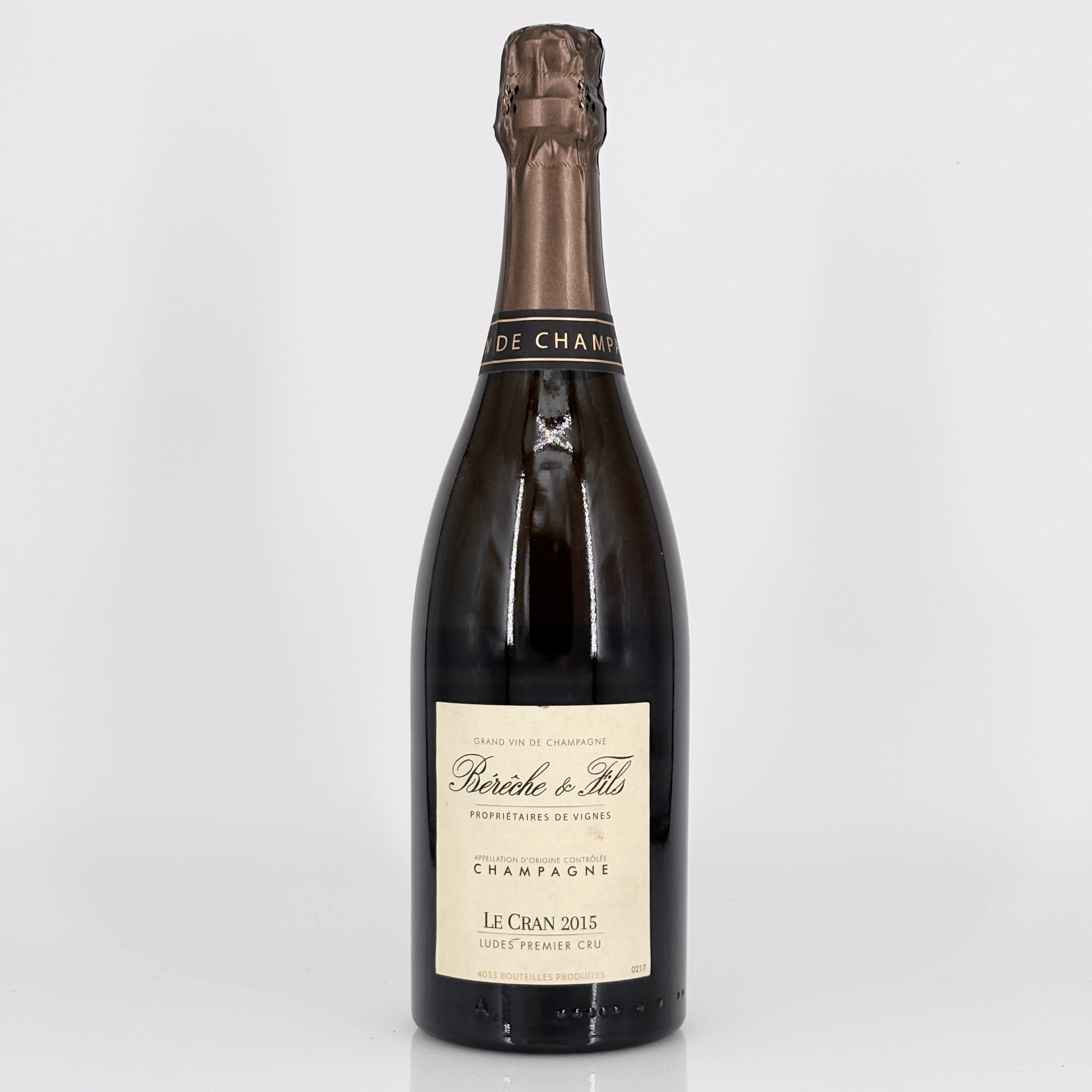 Bottle of champagne with a visible label on a white background 