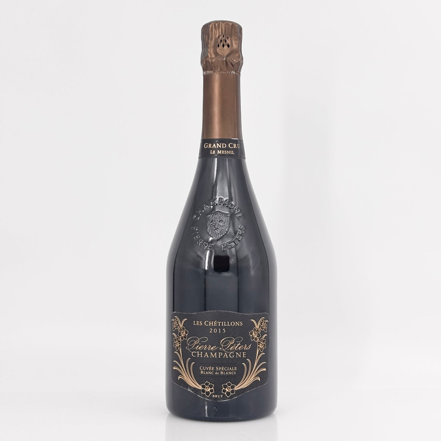 Bottle of champagne with a decorative label on a white background