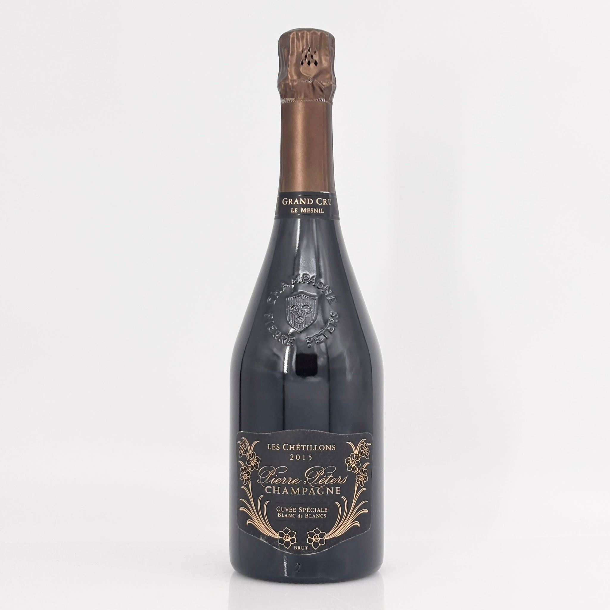 Bottle of champagne with a decorative label on a white background