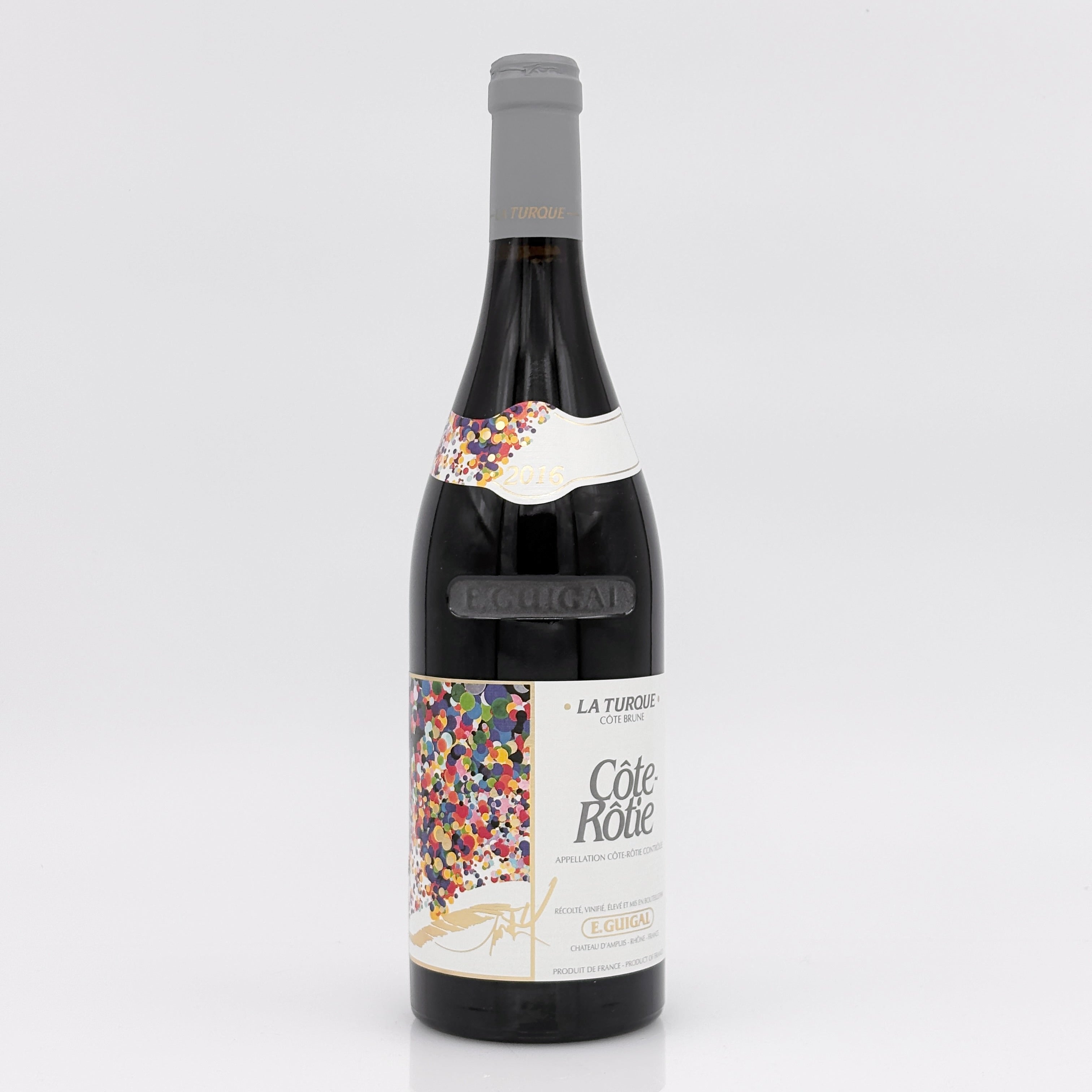 Red wine bottle with a colorful label on a white background