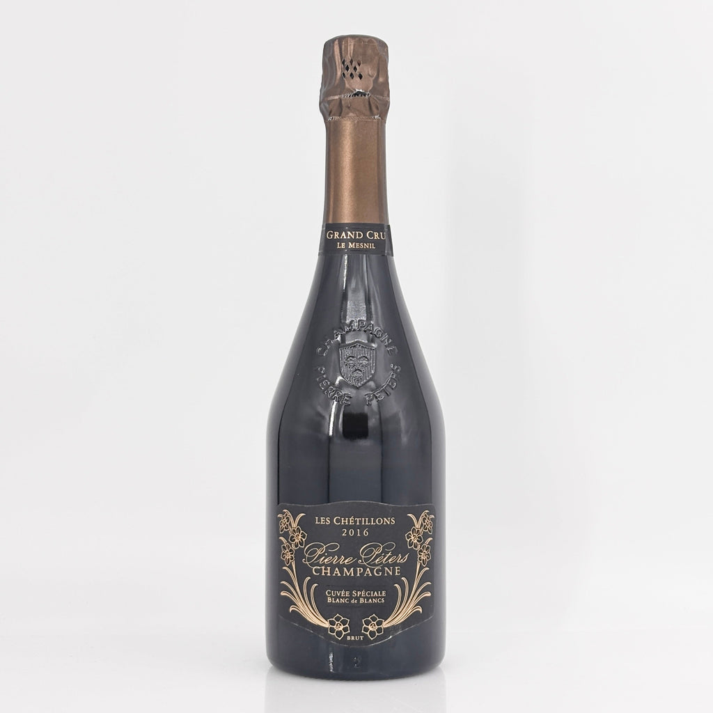 Bottle of champagne with a decorative label on a white background