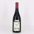 Red wine bottle with a visible label on a white background