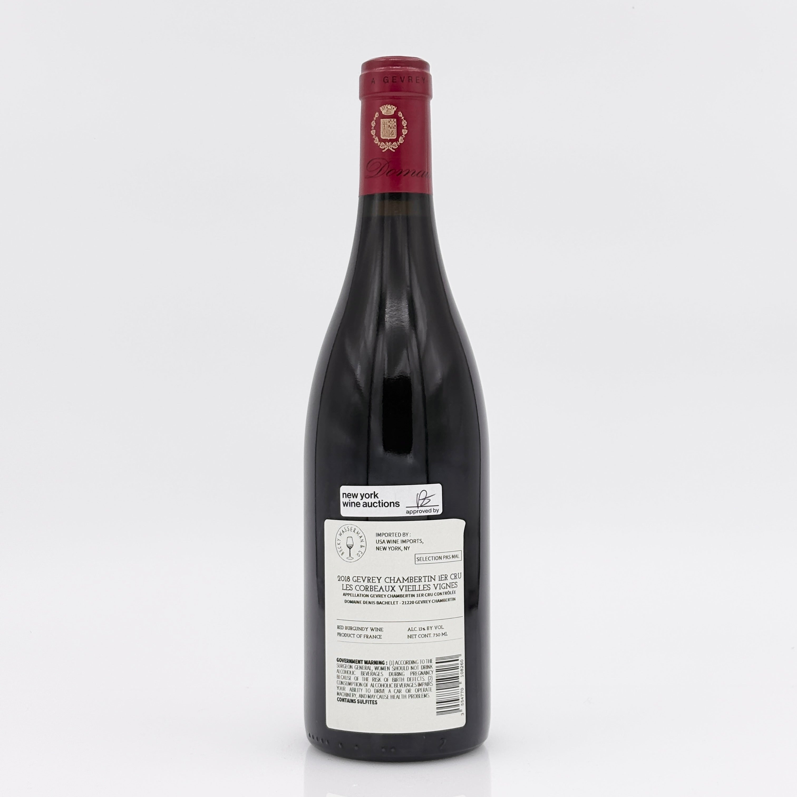 Red wine bottle with a visible label on a white background