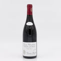 Red wine bottle with a white label on a light gray background