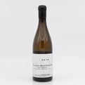 Wine bottle labeled 'Puligny-Montrachet' on a white background
