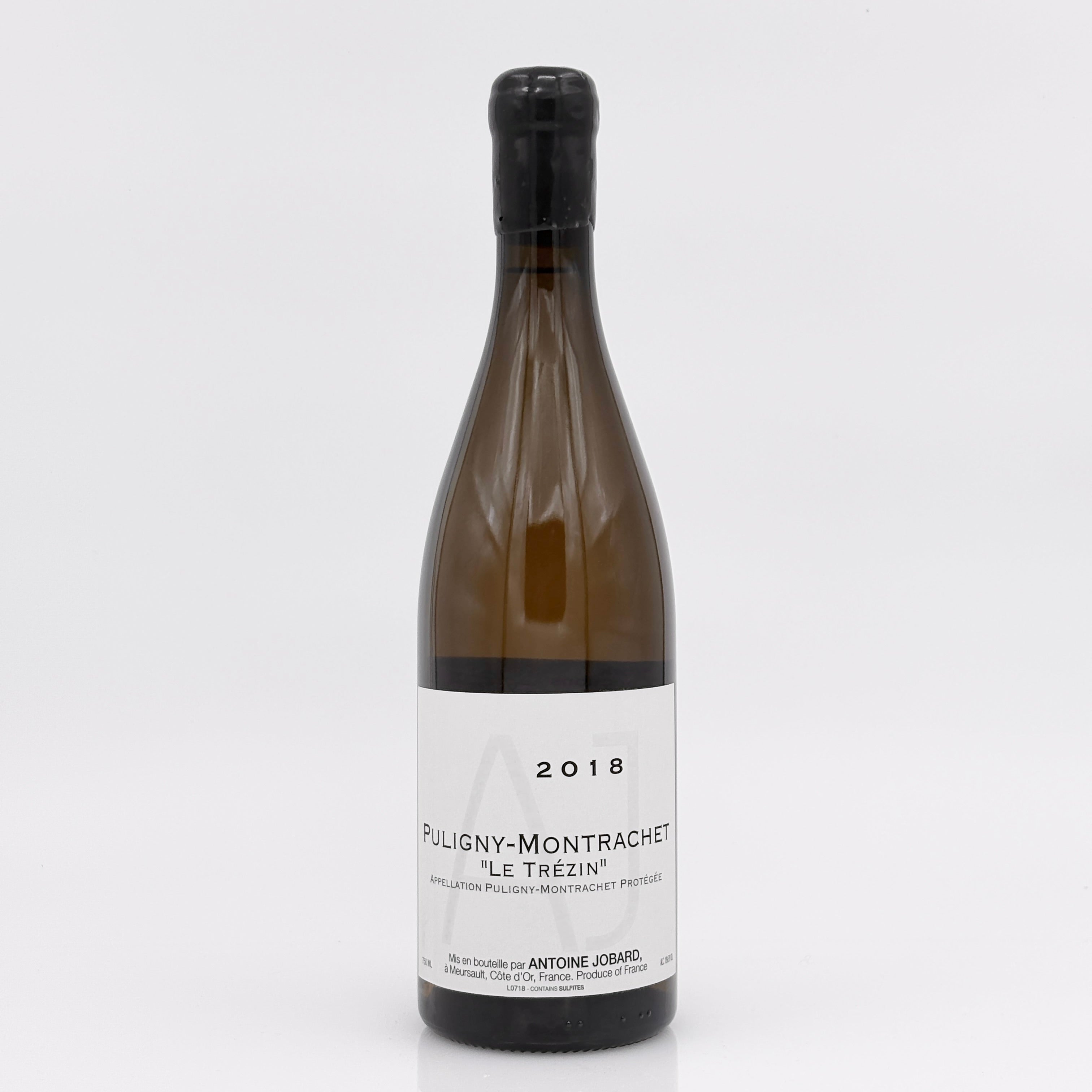 Wine bottle labeled 'Puligny-Montrachet' on a white background