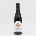 Wine bottle with a white label on a light gray background