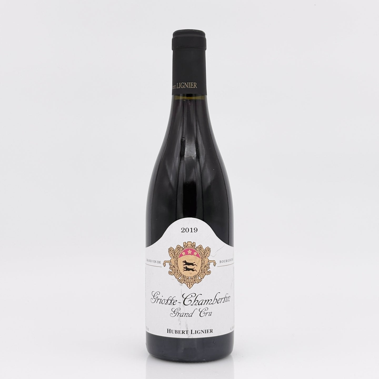 Wine bottle with a white label on a light gray background