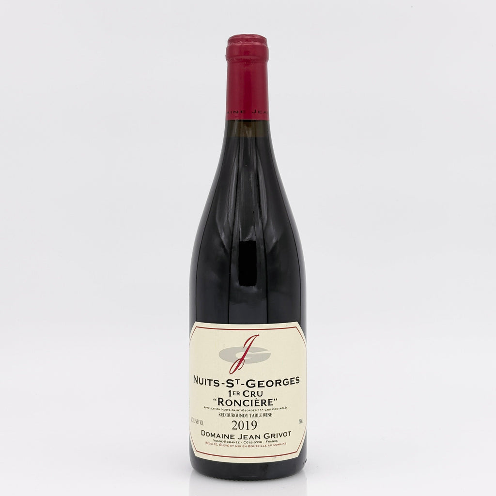 Red wine bottle with a visible label on a white background