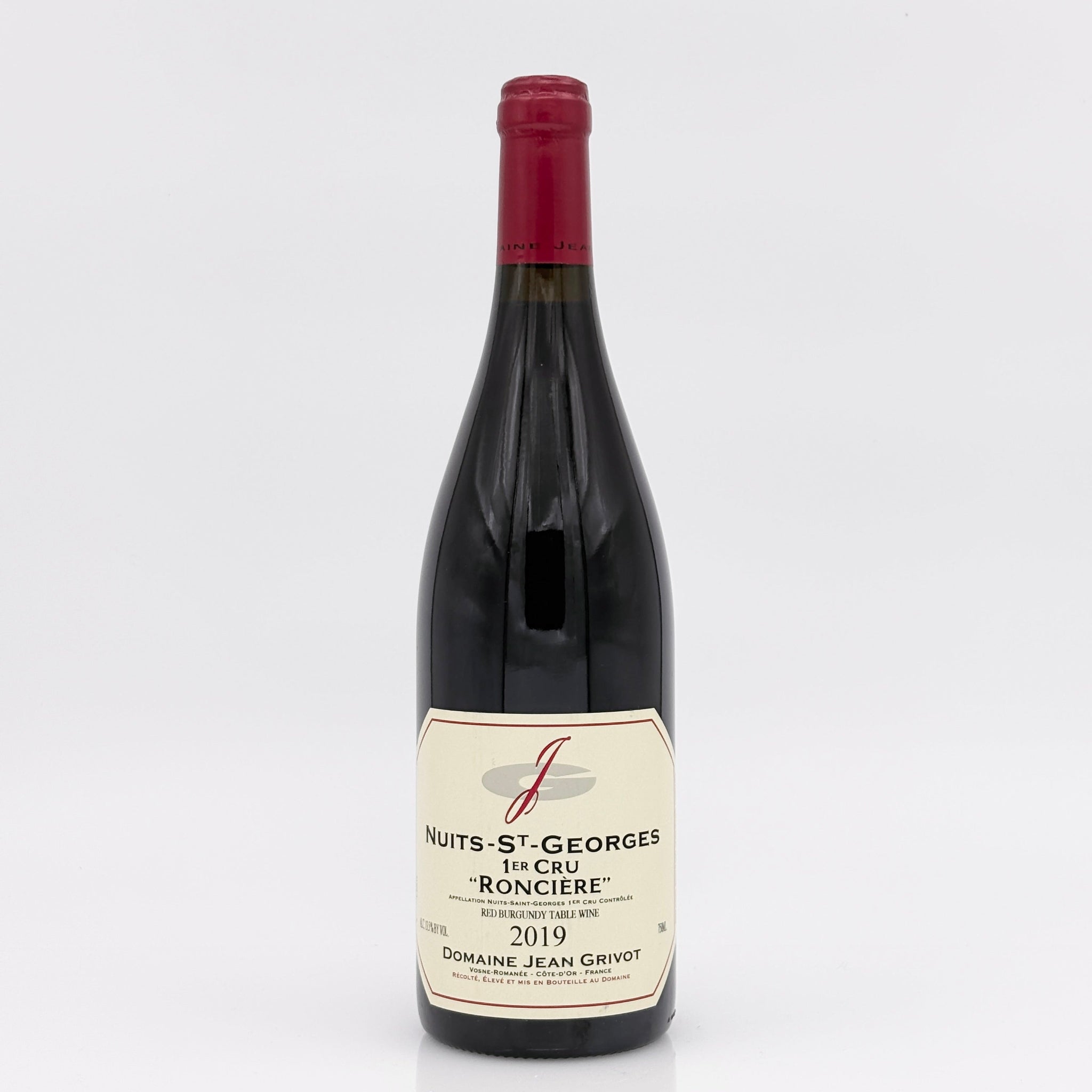 Red wine bottle with a visible label on a white background