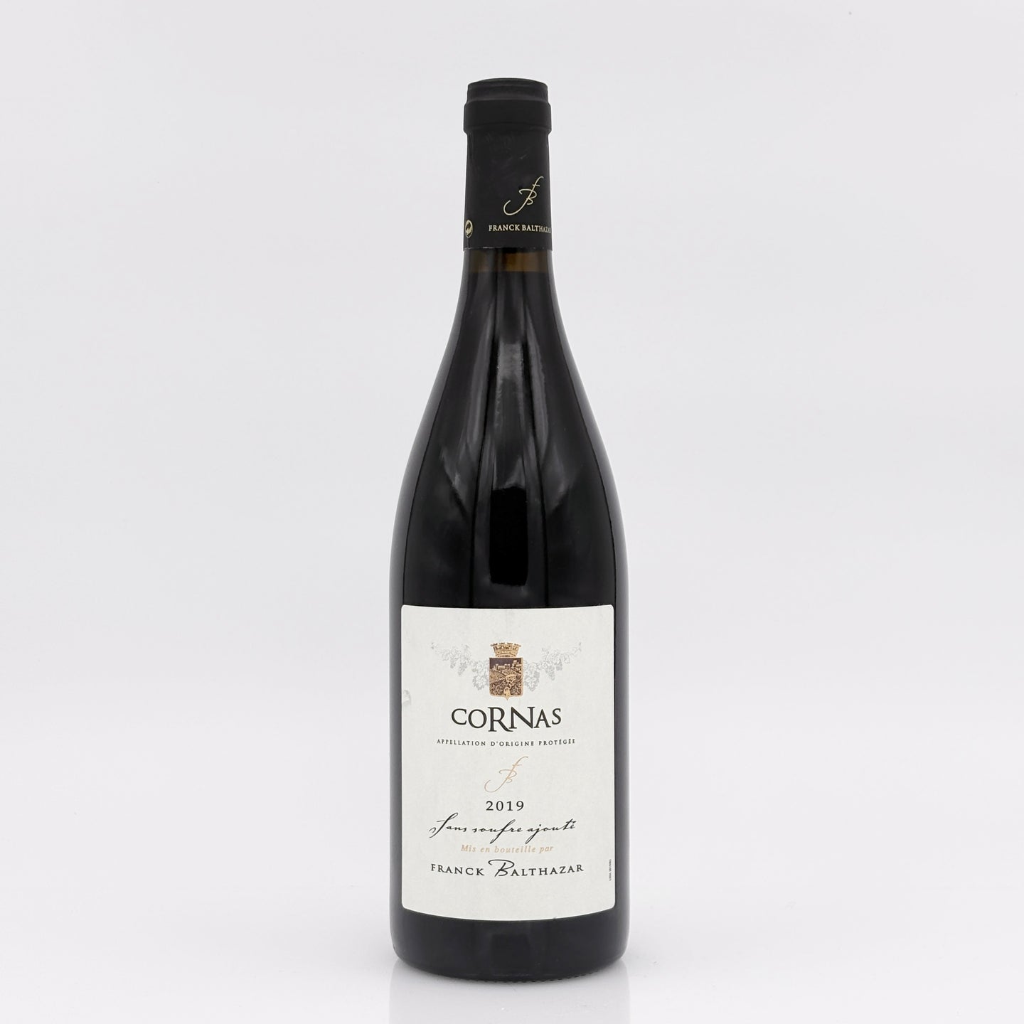 Wine bottle with 'Cornas' label on a white background